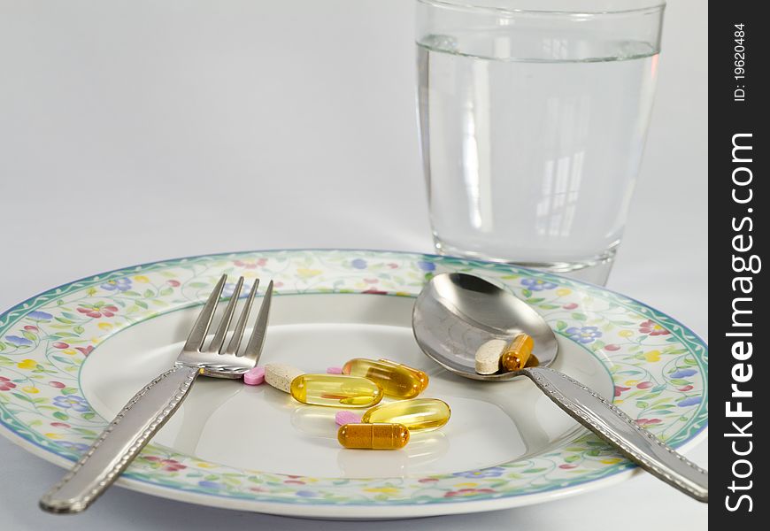 Various pills on dish, everyday meal time