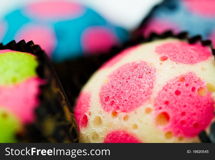 Close up view of the delicious colorful cup cakes surface. Close up view of the delicious colorful cup cakes surface