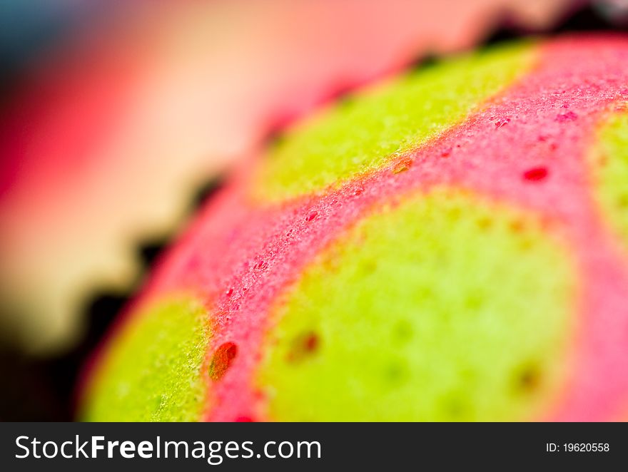 Extreme close up view of the delicious colorful cup cakes showing craters. Extreme close up view of the delicious colorful cup cakes showing craters
