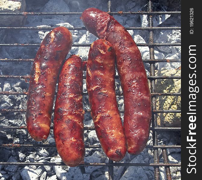 Tasty sausages on the grill, closeup