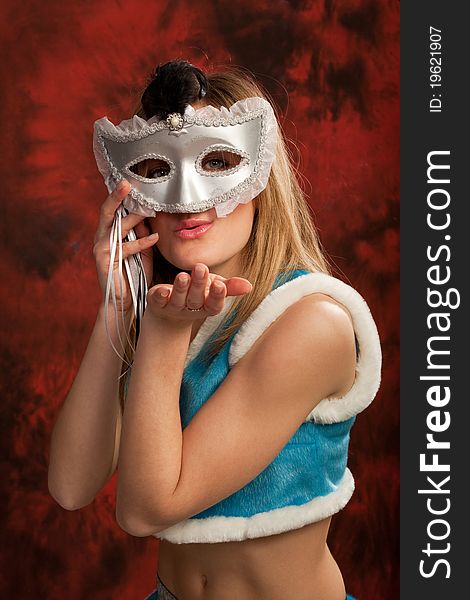 Photo of the young girl in costume of snowmaiden wearing a silver mask. Photo of the young girl in costume of snowmaiden wearing a silver mask