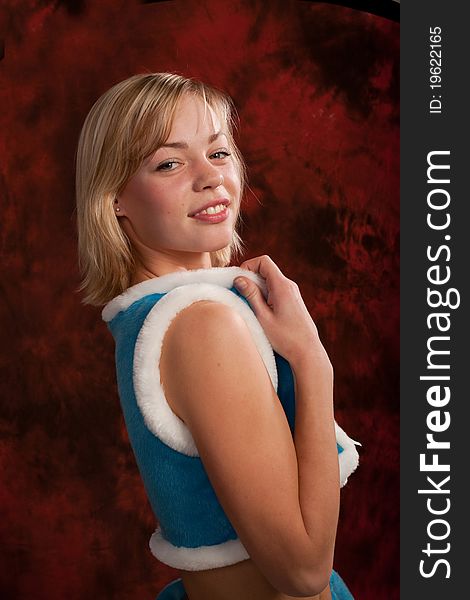 Photo of a young girl in costume of snow maiden, playfully smiling and posing to the camera. Photo of a young girl in costume of snow maiden, playfully smiling and posing to the camera