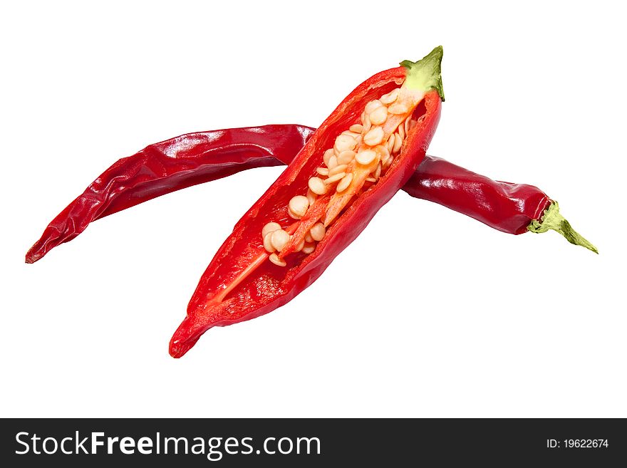 Red pepper chili isolated on white background, one is cut to show the seeds. Red pepper chili isolated on white background, one is cut to show the seeds