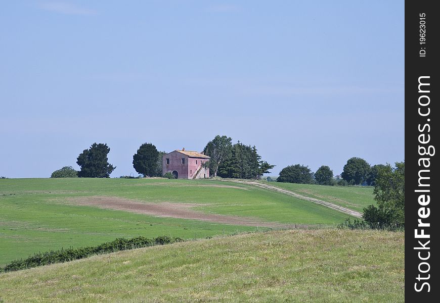 Italian Countryside, with a reddish country house in the centre. Italian Countryside, with a reddish country house in the centre