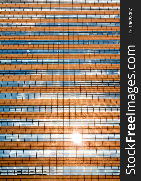 Facade of a modern skyscraper reflecting sun