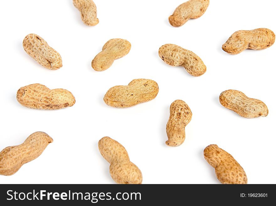 Groundnuts in peels background on white