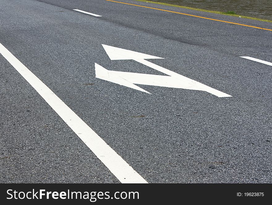 Arrows showing the left and straight on the road. Arrows showing the left and straight on the road.