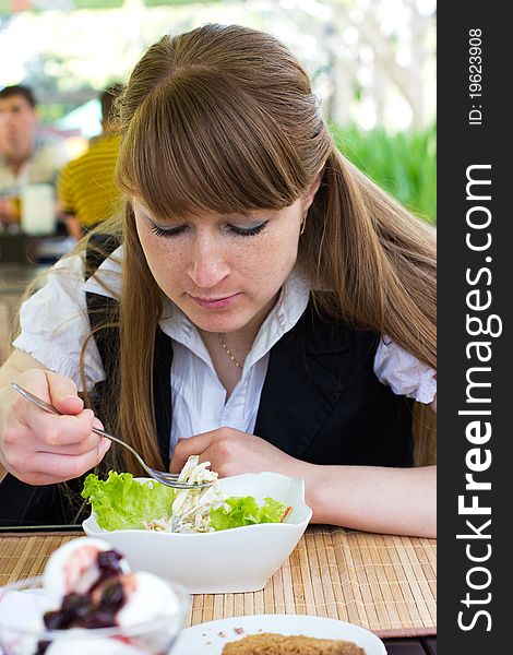 Young Woman Eating Salad