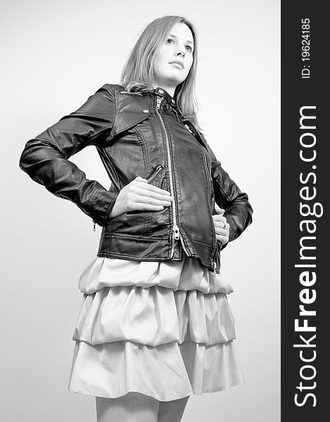 Portrait of an attractive beautiful blond woman in a dress and black leather jacket. Portrait of an attractive beautiful blond woman in a dress and black leather jacket