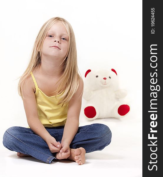 Young girl with teddy bear in background. Young girl with teddy bear in background.