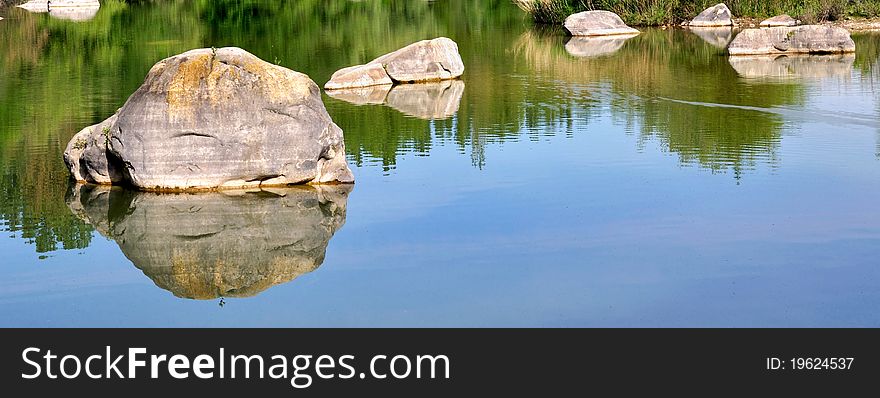 Rocks Scattered In The Lake Water