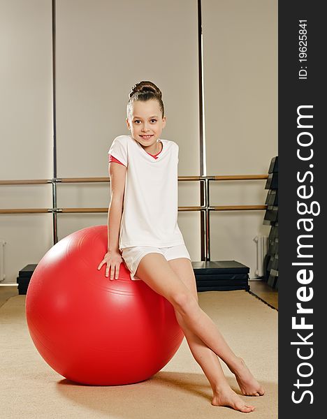 Portrait of young beauty gymnast in gymnasium on the ball. Portrait of young beauty gymnast in gymnasium on the ball