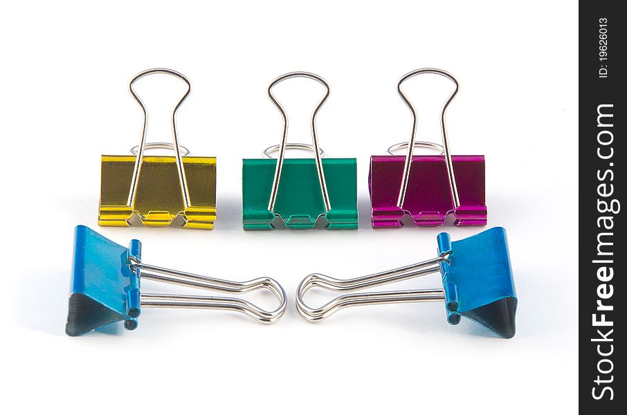 Five colored stationery clips on a white background