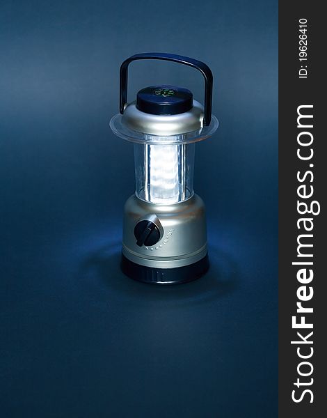 Luminous battery powered camping lamp on dark background. Luminous battery powered camping lamp on dark background