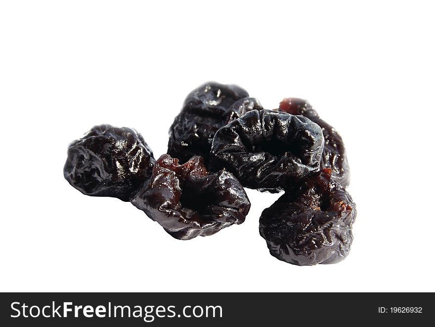 Group of dried black plums isolated on white background