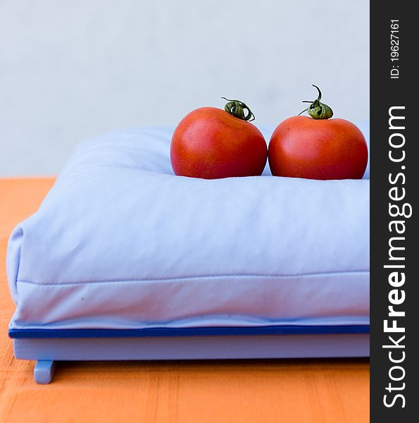 Two tomatoes on a pillow
