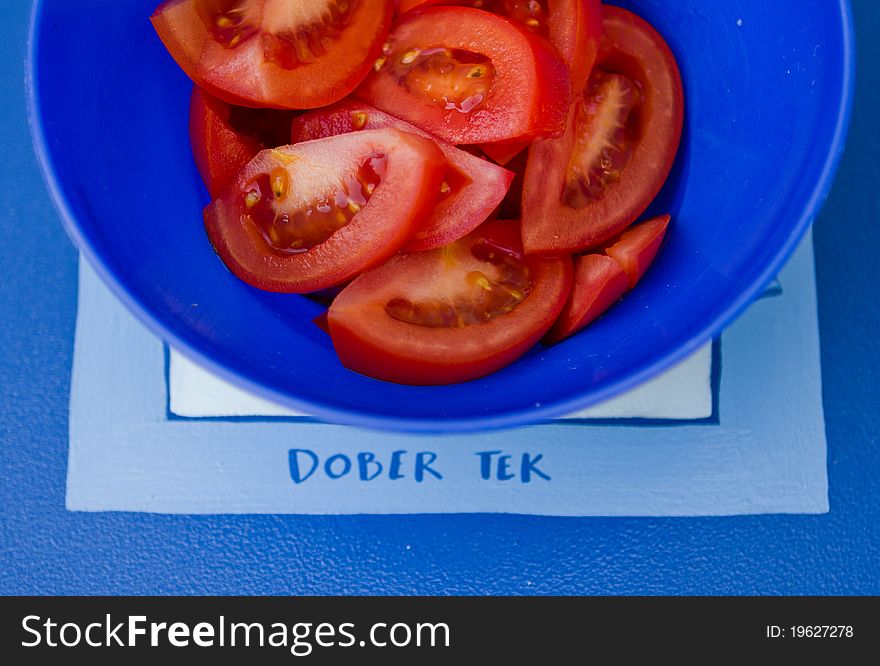 Tomato salad with saying dober tek which means bon appetite