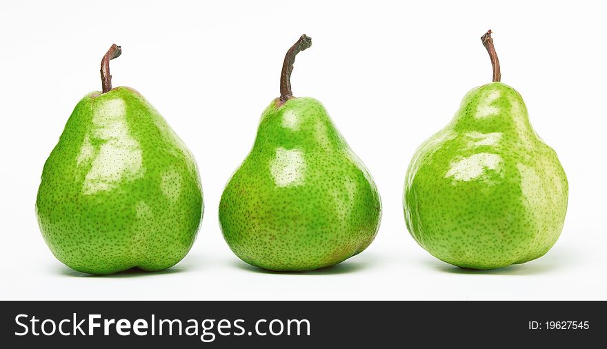 Three green pears on white background