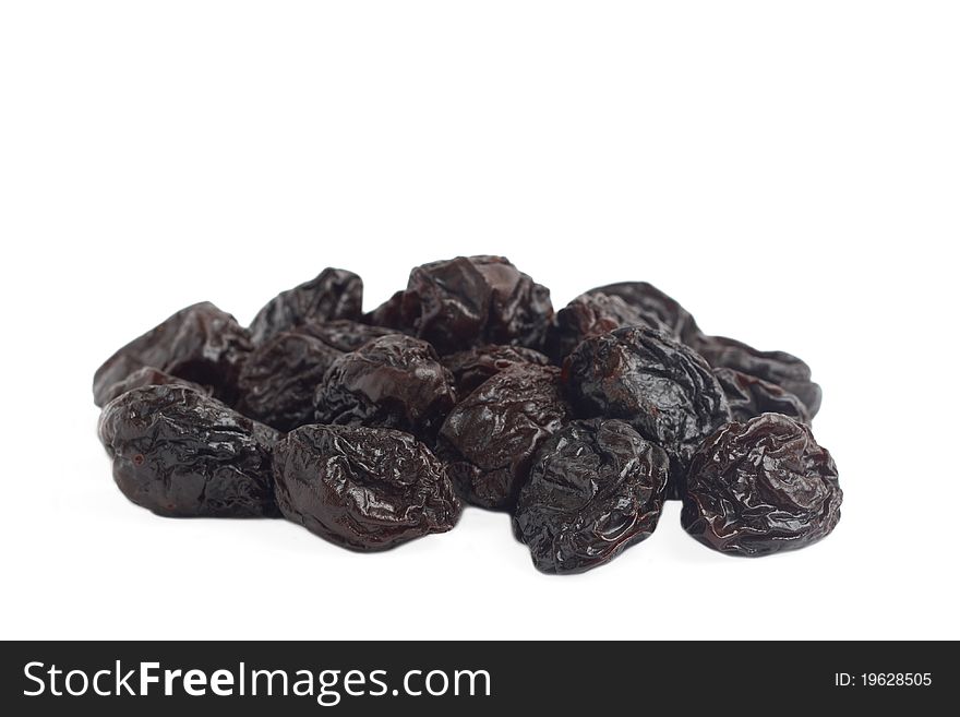 Stack of dried plum prunes on white background. Stack of dried plum prunes on white background