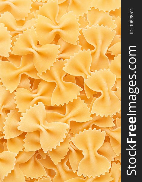 Closeup of Bow tie pasta Farfalloni forming a background. Closeup of Bow tie pasta Farfalloni forming a background