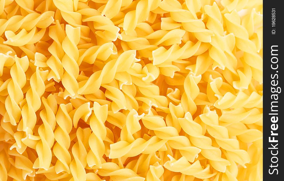Closeup of Fusilli swirl pasta forming a background