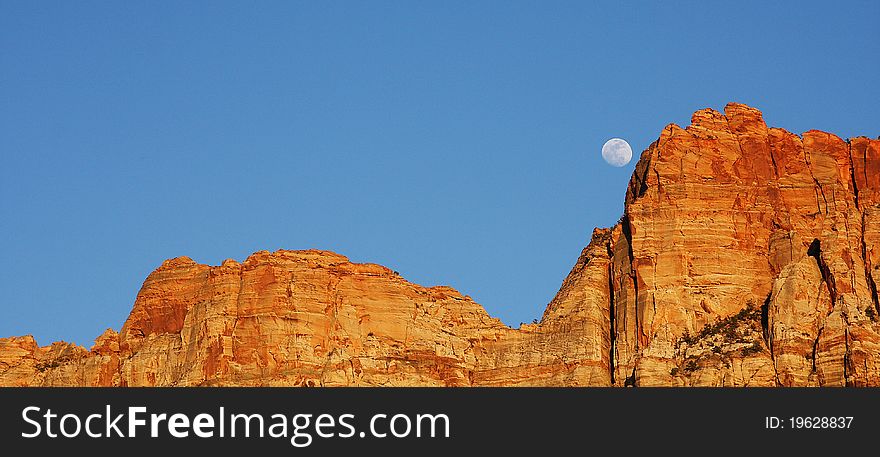 Moon coming up over the Red Sandstone rock in Zion National Park located in Southern Utah. Moon coming up over the Red Sandstone rock in Zion National Park located in Southern Utah.