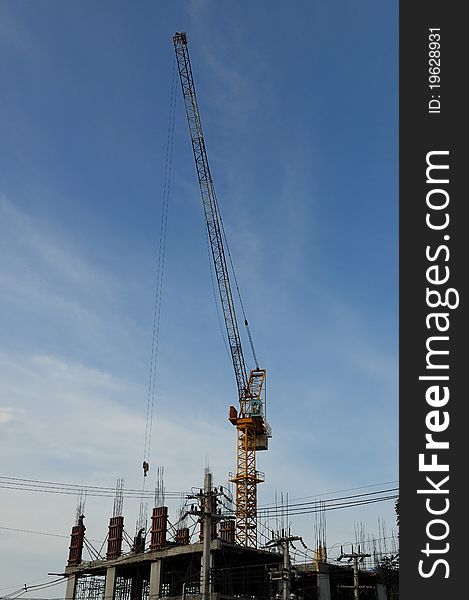 A crane on an under-construction building. A crane on an under-construction building