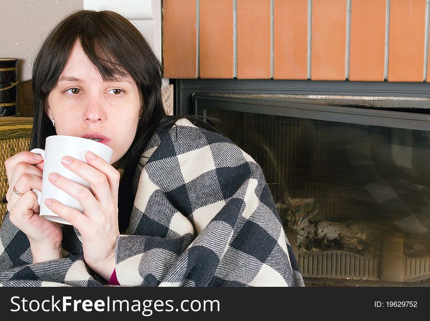 A woman drinking from white cup