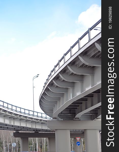 Automobile overpass on background of blue sky with clouds. bottom view