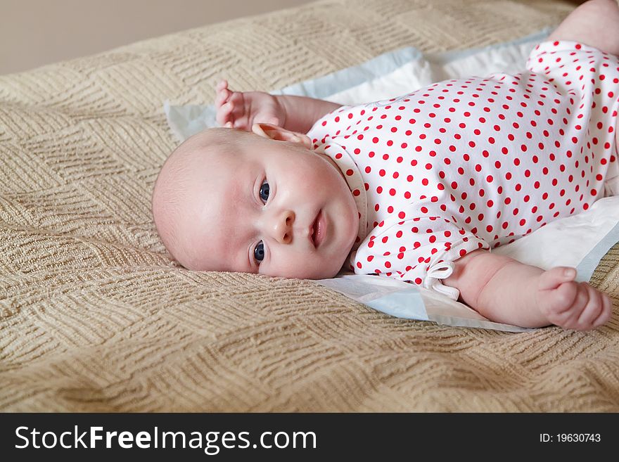 Little newborn girl lying on a white diaper. Little newborn girl lying on a white diaper