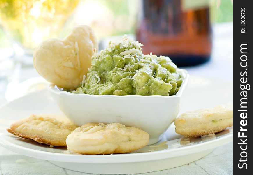 Bowl of fresh guacamole with cookies. Selective focus. Bowl of fresh guacamole with cookies. Selective focus