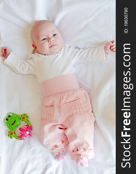 Little newborn girl lying on a white diaper. Little newborn girl lying on a white diaper