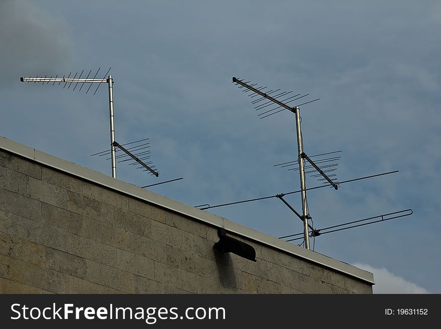 Old analog television antenna cloudy sky on the background