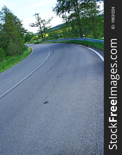 Road curve at a pond.