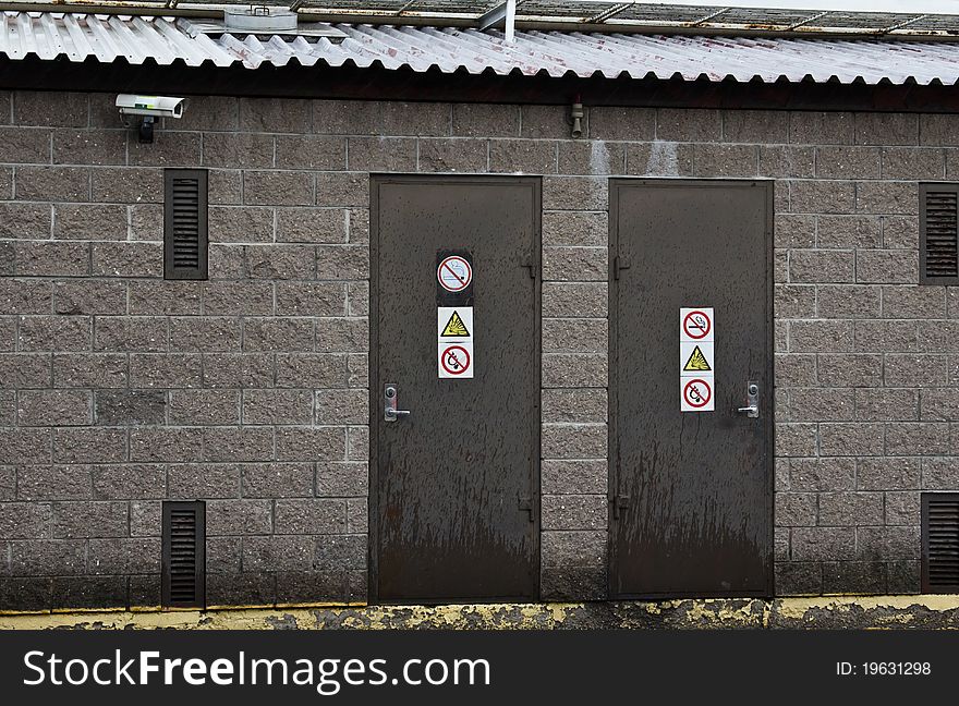 Two doors with prohibitory signsÐ± rainy weather