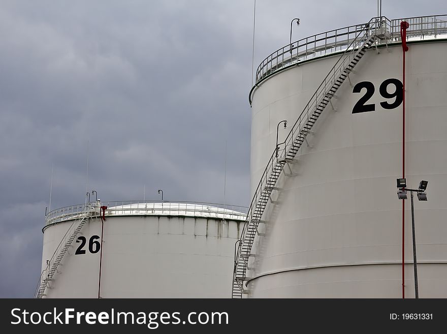 Tanks in oil refinery factory on the cloudy sky. Tanks in oil refinery factory on the cloudy sky