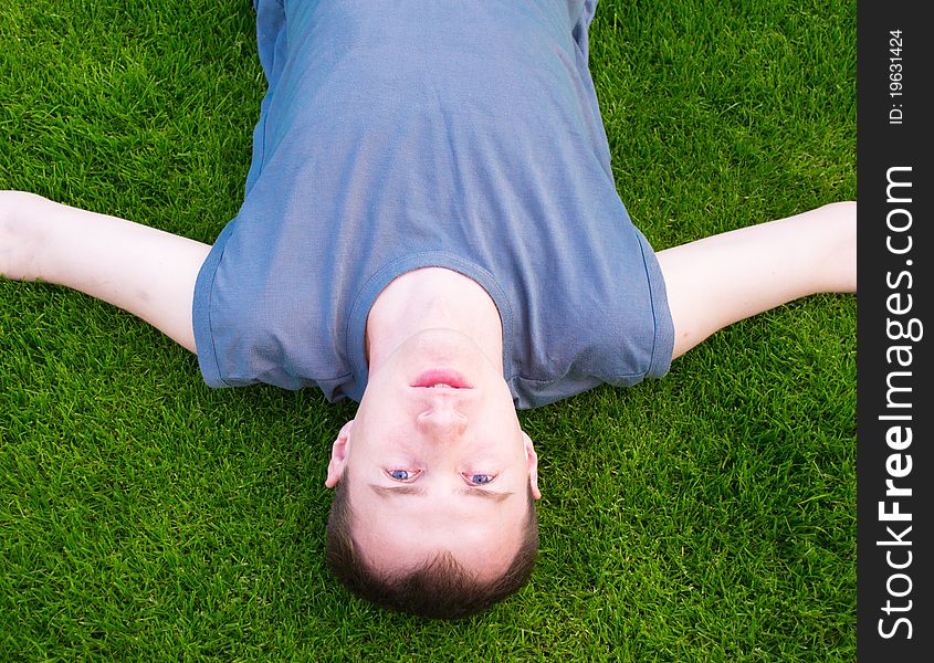 Young man lying on green grass. Young man lying on green grass