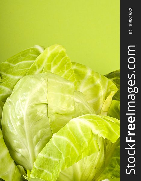 Fresh cabbage on green background