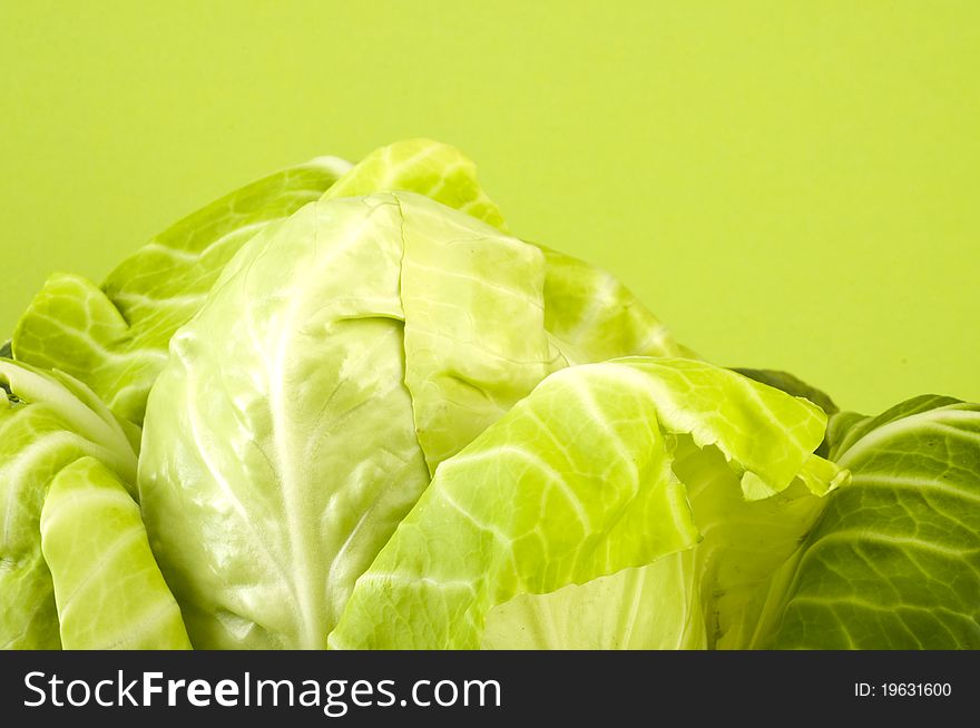Fresh cabbage on green background