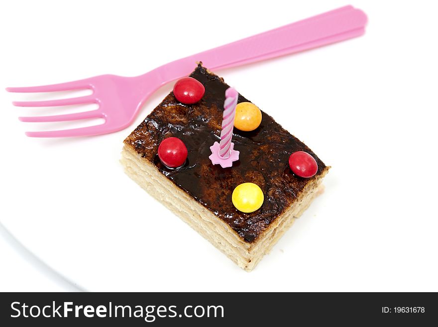 Isolated cake with a pink fork. Isolated cake with a pink fork