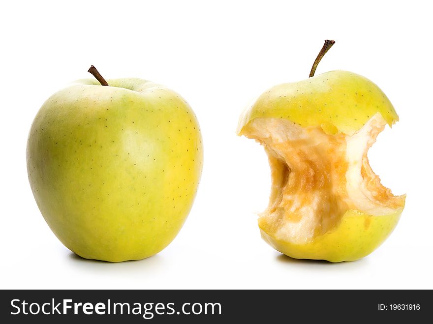An apple and an apple core in front of white background