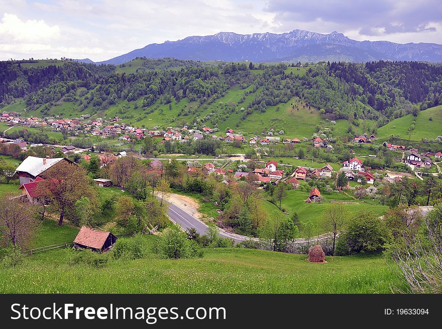 Curved road cut a valley village. Curved road cut a valley village