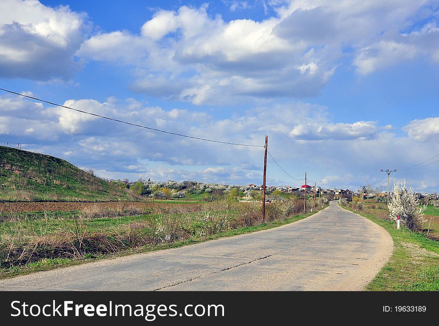 Curved road under cloudy sky