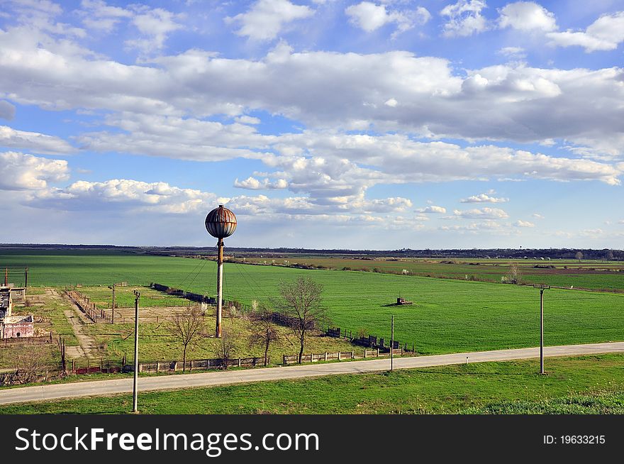 Water tower on sunny field