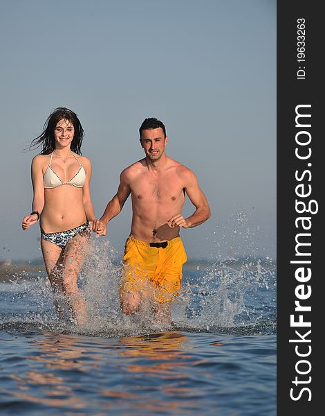 Happy young couple have fun on beach