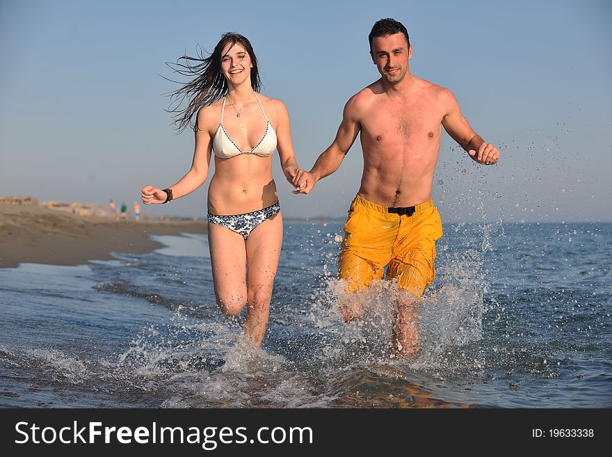 Happy young couple have fun and romantic moments on beach at summer season and representing happynes and travel concept. Happy young couple have fun and romantic moments on beach at summer season and representing happynes and travel concept