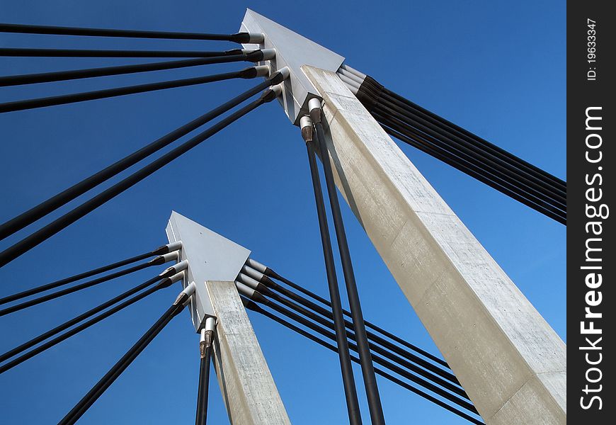 Closeup of bridge construction over blue sky