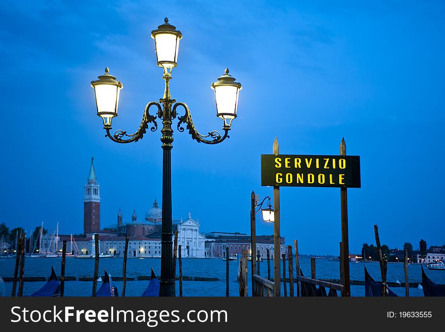 Sign for gondola dock in Venice, Italy, at twilight