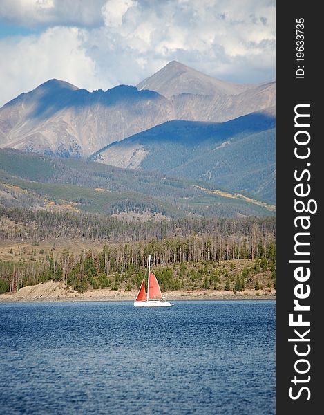 Looking across lake Dillon, Colorado showing a sailboat on the lake and the mountains beyond. Looking across lake Dillon, Colorado showing a sailboat on the lake and the mountains beyond