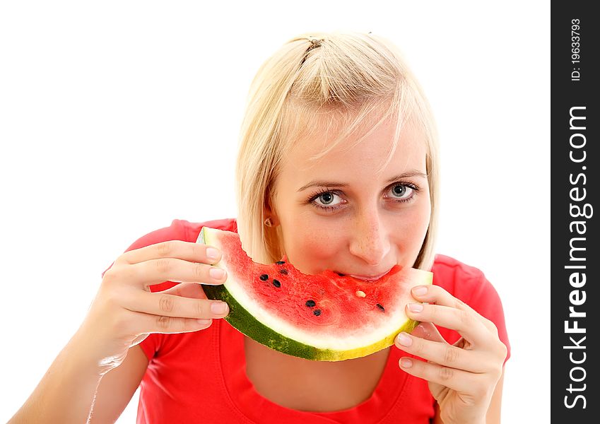 A pretty young girl eating a piece of watermelon. A pretty young girl eating a piece of watermelon